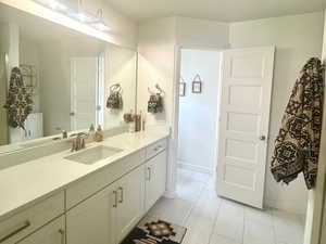 Master Bathroom with vanity and marble look tiles