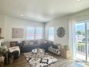 Living room featuring hardwood / wood-style flooring, plenty of natural light, and recessed lighting