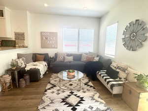 Living room featuring wood finished floors and recessed lighting