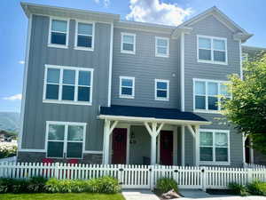 View of front of house with board and batten siding and covered porch