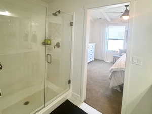 Master bathroom with a shower stall, baseboards, and tile patterned floors