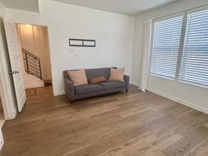 Living area featuring stairs, wood finished floors, and baseboards