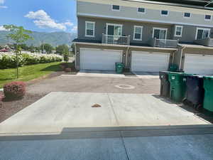 View of front of house featuring a mountain view, a garage, and concrete driveway
