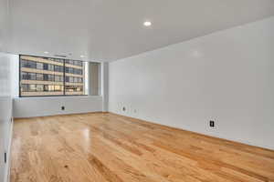 Empty room with wood finished floors and recessed lighting