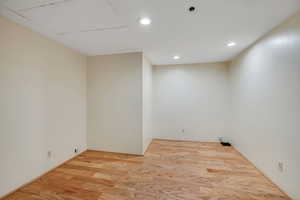 Laundry room featuring wood finished floors and recessed lighting