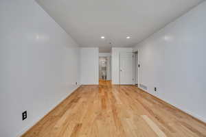 Empty room featuring recessed lighting, light wood finished floors, and baseboards