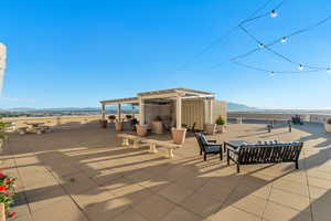 View of patio / terrace featuring a mountain view, a pergola, area for grilling, and an outdoor hangout area