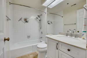 Full bathroom featuring vanity, washtub / shower combination, toilet, and tile patterned flooring