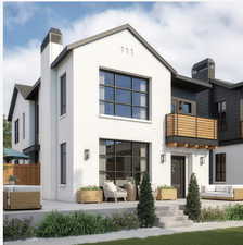 Back of house featuring a balcony, outdoor lounge area, and a chimney