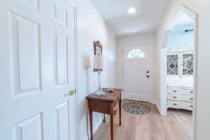 Entryway with light wood-style flooring, baseboards, and recessed lighting