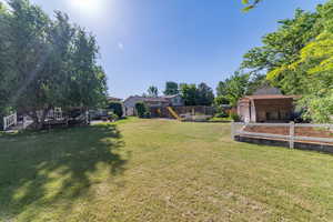 View of yard with a playground and a wooden deck