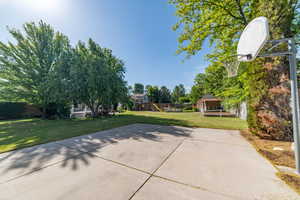 View of patio / terrace with a playground and basketball hoop