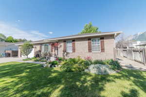 Ranch-style home featuring brick siding