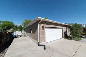 View of side of home featuring brick siding and driveway