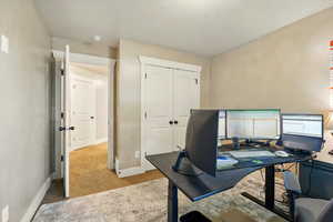 Home office with carpet and baseboards