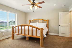 Bedroom featuring carpet flooring, baseboards, recessed lighting, and ceiling fan