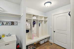Mudroom with baseboards and a sink