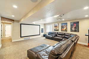 Home theater featuring carpet, baseboards, and recessed lighting