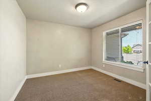 Empty room featuring carpet floors and baseboards