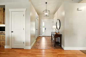 Entryway featuring baseboards and light wood finished floors