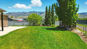 View of yard featuring a mountain view and a patio area