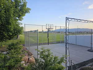 View of basketball court with basketball standard and net.