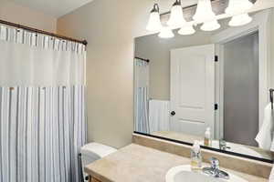 Full bath featuring vanity and toilet
