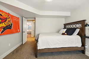 Bedroom featuring carpet floors and baseboards