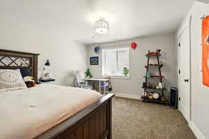 Carpeted bedroom with baseboards