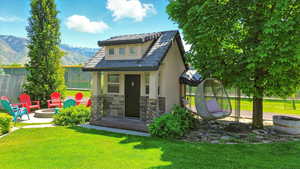 View of outbuilding featuring an outdoor fire pit and a mountain view