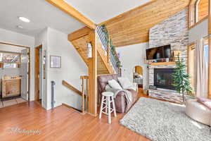 Living area featuring wood finished floors, a fireplace, and baseboards