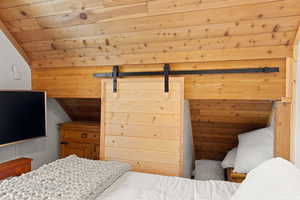 Bedroom with wooden ceiling
