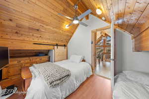 Bedroom with wooden ceiling, lofted ceiling, and wood finished floors