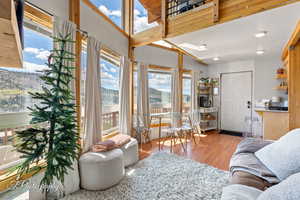 Living area with plenty of natural light and wood finished floors
