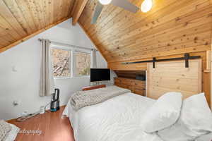 Bedroom featuring wood finished floors and wooden ceiling