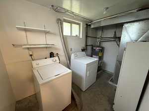 Washroom featuring separate washer and dryer and electric water heater