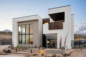 Rear view of house with stucco siding and a mountain view