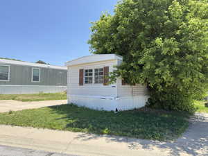 View of side of property featuring a lawn