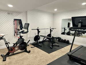 Exercise room with recessed lighting, baseboards, and carpet