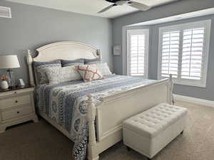 Bedroom with carpet, baseboards, and a ceiling fan