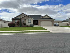 Ranch-style house with concrete driveway, brick siding, and an attached garage