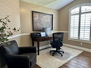 Office with healthy amount of natural light, wood finished floors, and baseboards