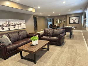 Rec room featuring light carpet, recessed lighting, baseboards, and arched walkways