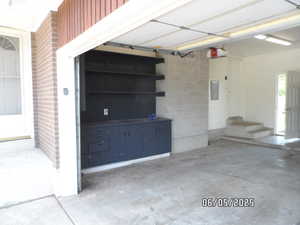 Garage with electric panel, garage door opener and work bench