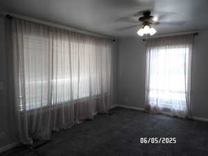 Living room featuring ceiling fan, baseboards, and carpet floors