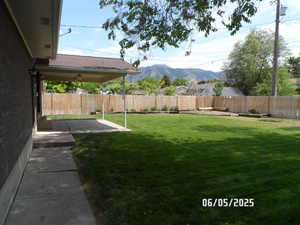 View of yard featuring a mountain view and a patio area