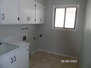 Laundry room with cabinet space, baseboards, hookup for an electric or gas dryer, washer hookup, and light tile floors