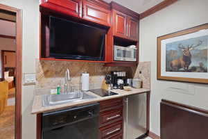 Kitchen with dishwasher, stainless steel microwave, a sink, refrigerator, and decorative backsplash