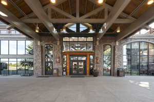 Entrance to property featuring french doors and stone siding