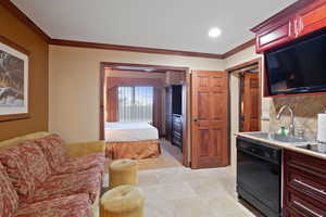 Kitchen with dishwasher, a sink, reddish brown cabinets, ornamental molding, and tasteful backsplash